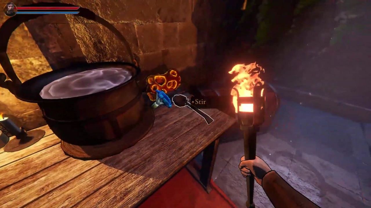 Holding a torch and looking toward a cauldron on a table, which has a spoon next to it.
