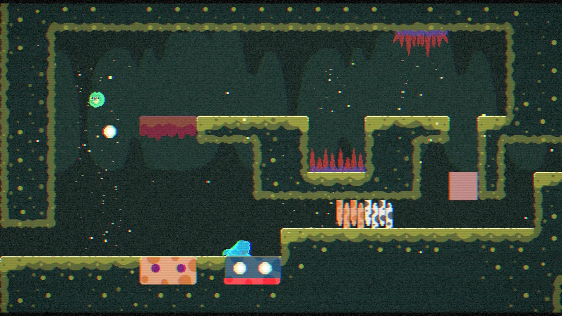 A blue blob moves right along some switches embedded in the ground. Overhead, a ledge contains a recess with a bed of spikes, and more spike protrude from the ceiling.