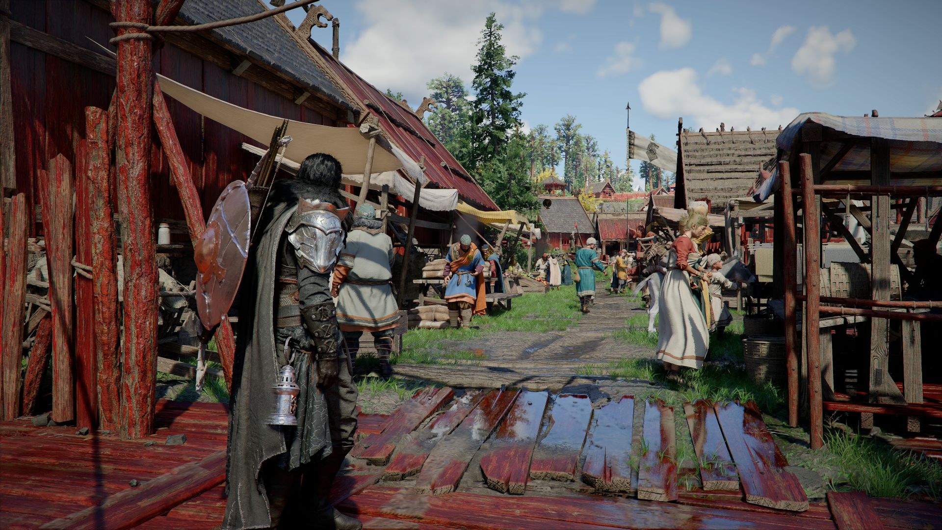 The hero walks along a street with red-colored planking, toward civilians engaged in bartering at the marketplace.