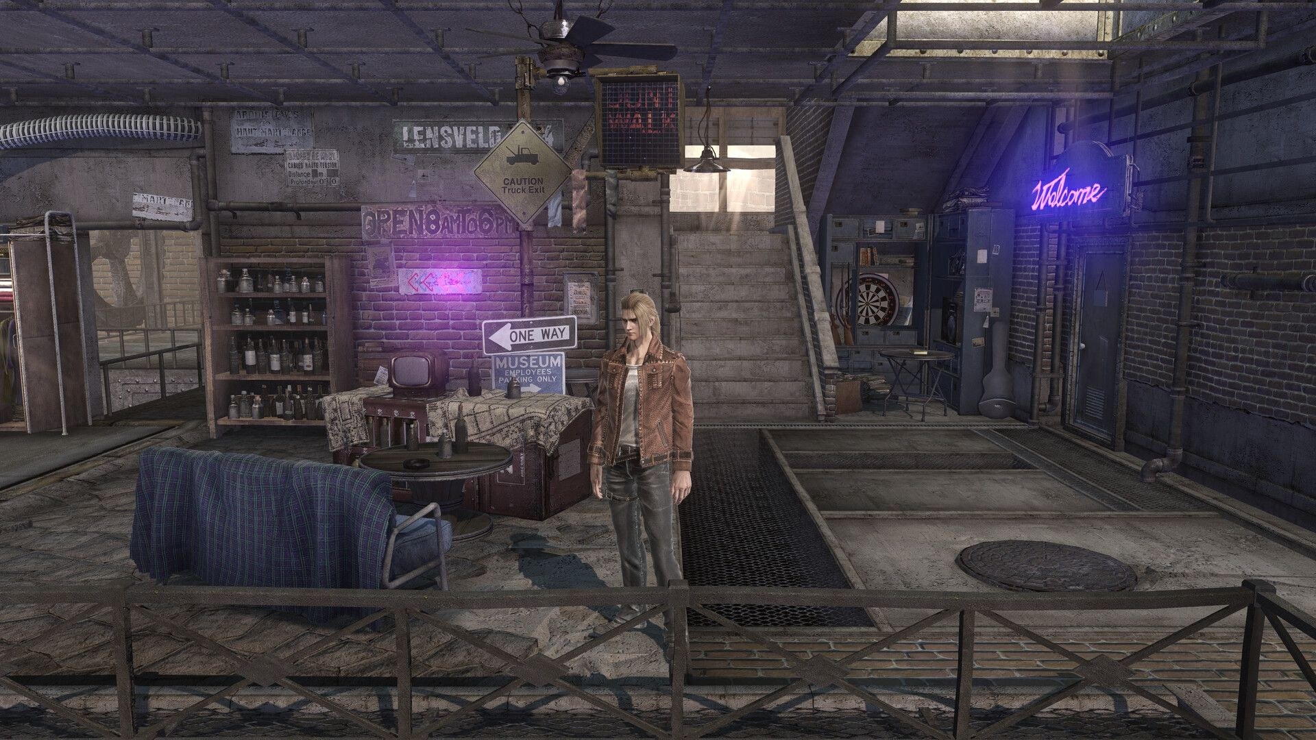 A man in a leather jacket stars out over a railing, while to his right, couches and a trunk with a television are positioned around a circular table.