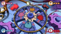 Players are on a giant rotating wheel with holes and obstacles, apparently trying to avoid being knocked into one of the large openings.